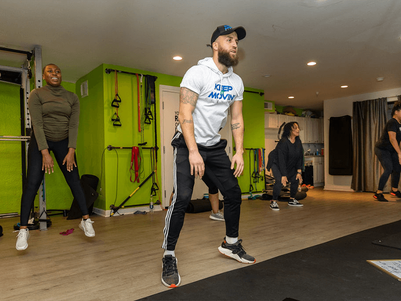 wednesday fitness class Cardio and Core helps burn calories for weight loss with lead trainer Dante Puchala pictured jumping and women jumping in the background